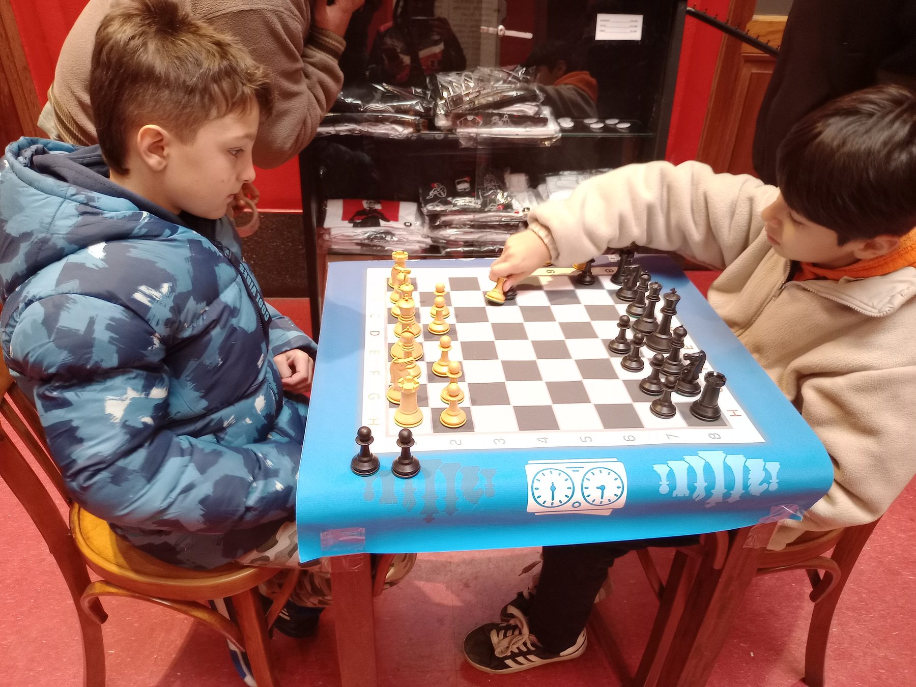 Niños jugando al ajedrez en una mesa